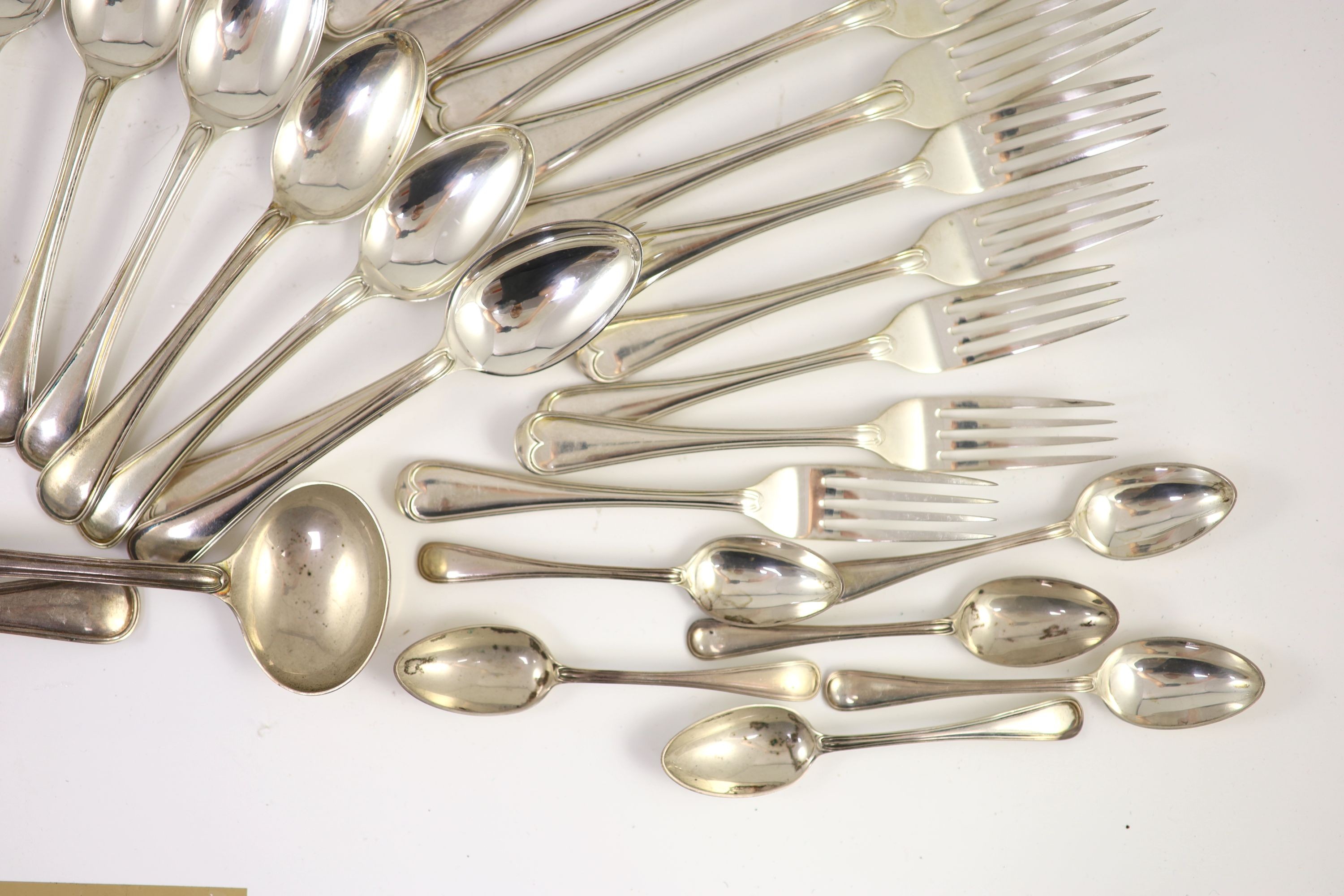 A part canteen of Edwardian silver Old English double struck thread pattern flatware for twelve by John Round & Son Ltd